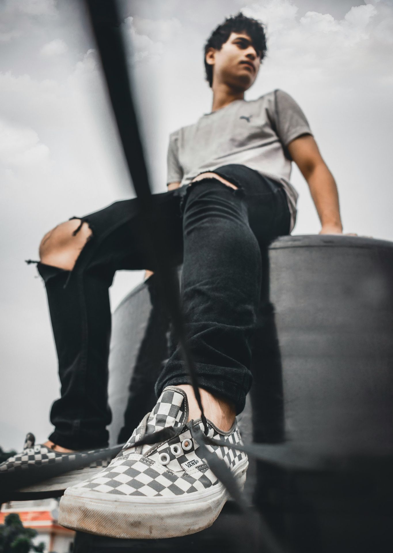 man wearing distressed black denim jeans close-up photography